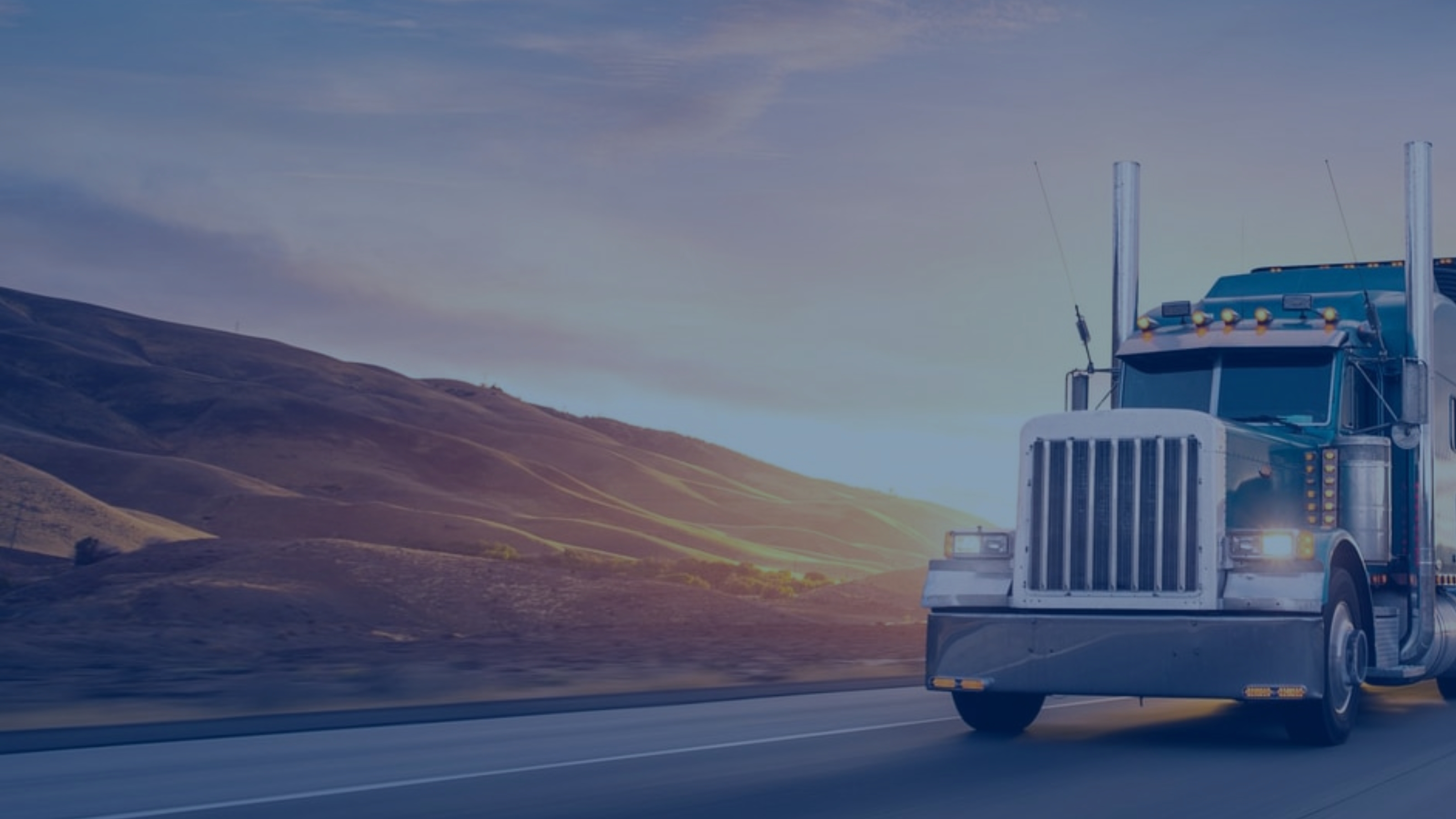 Blue diesel truck on highway with mountains